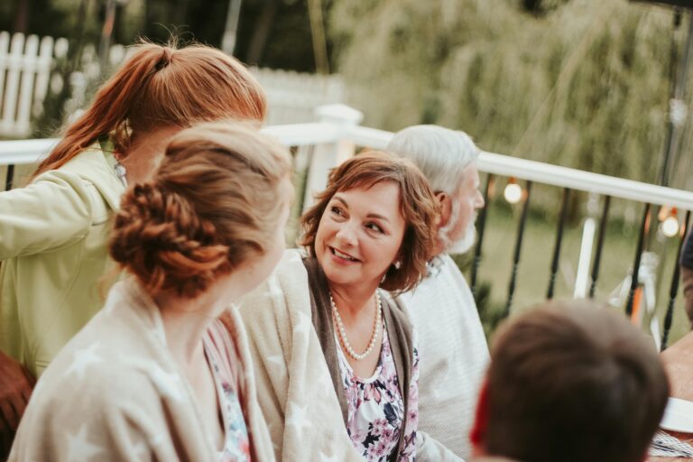 Family enjoying a cozy outdoor summer gathering with smiles and conversations.